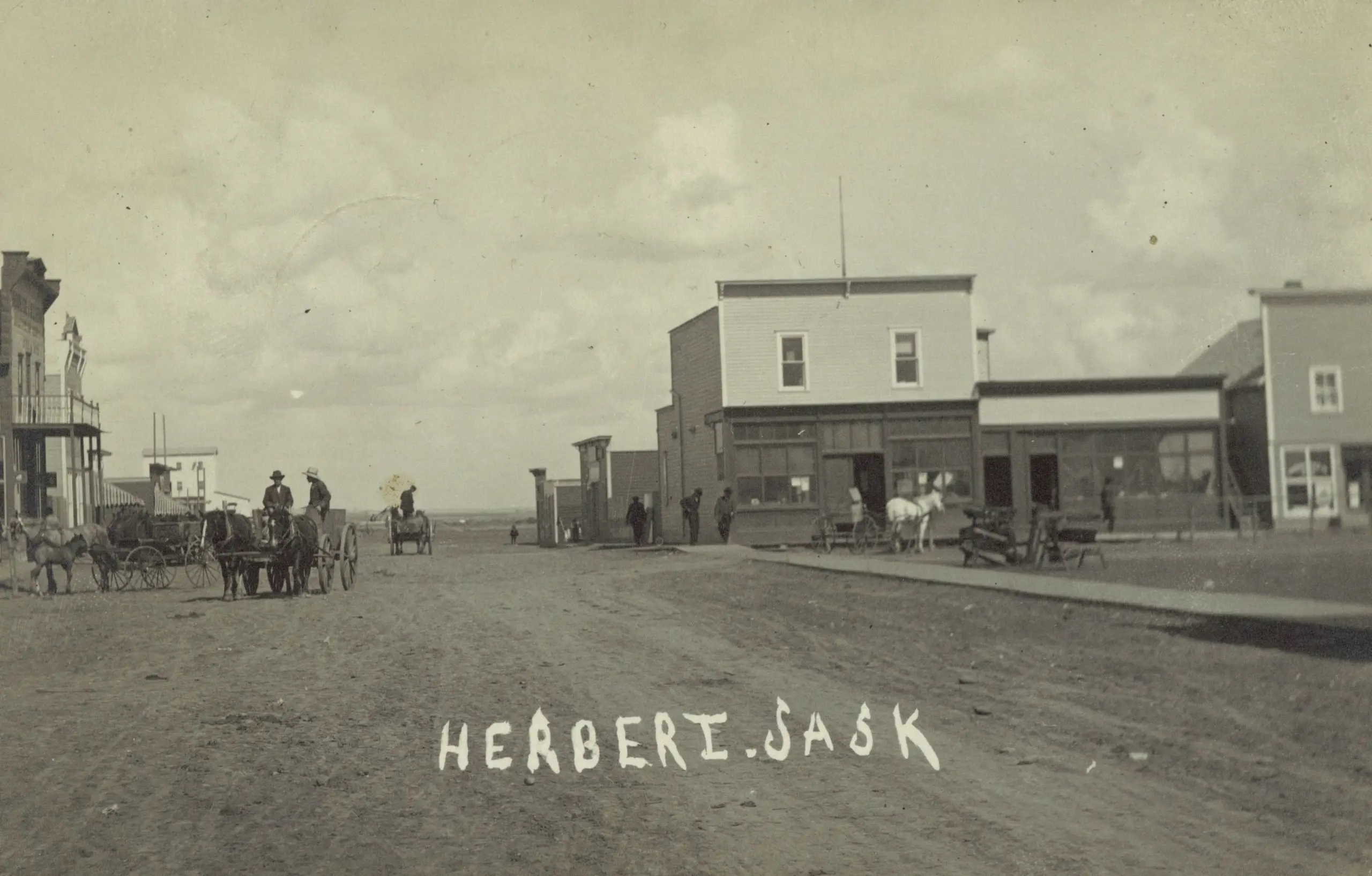 Street scene in Herbert with horse-drawn wagons