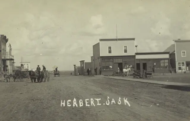 Street scene in Herbert with horse-drawn wagons