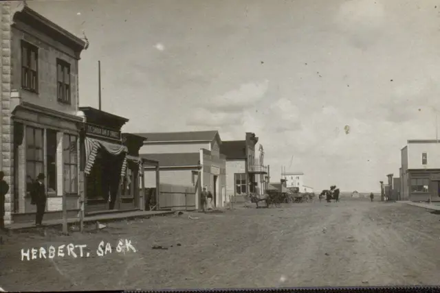 Street scene in Herbert with storefronts and wagons