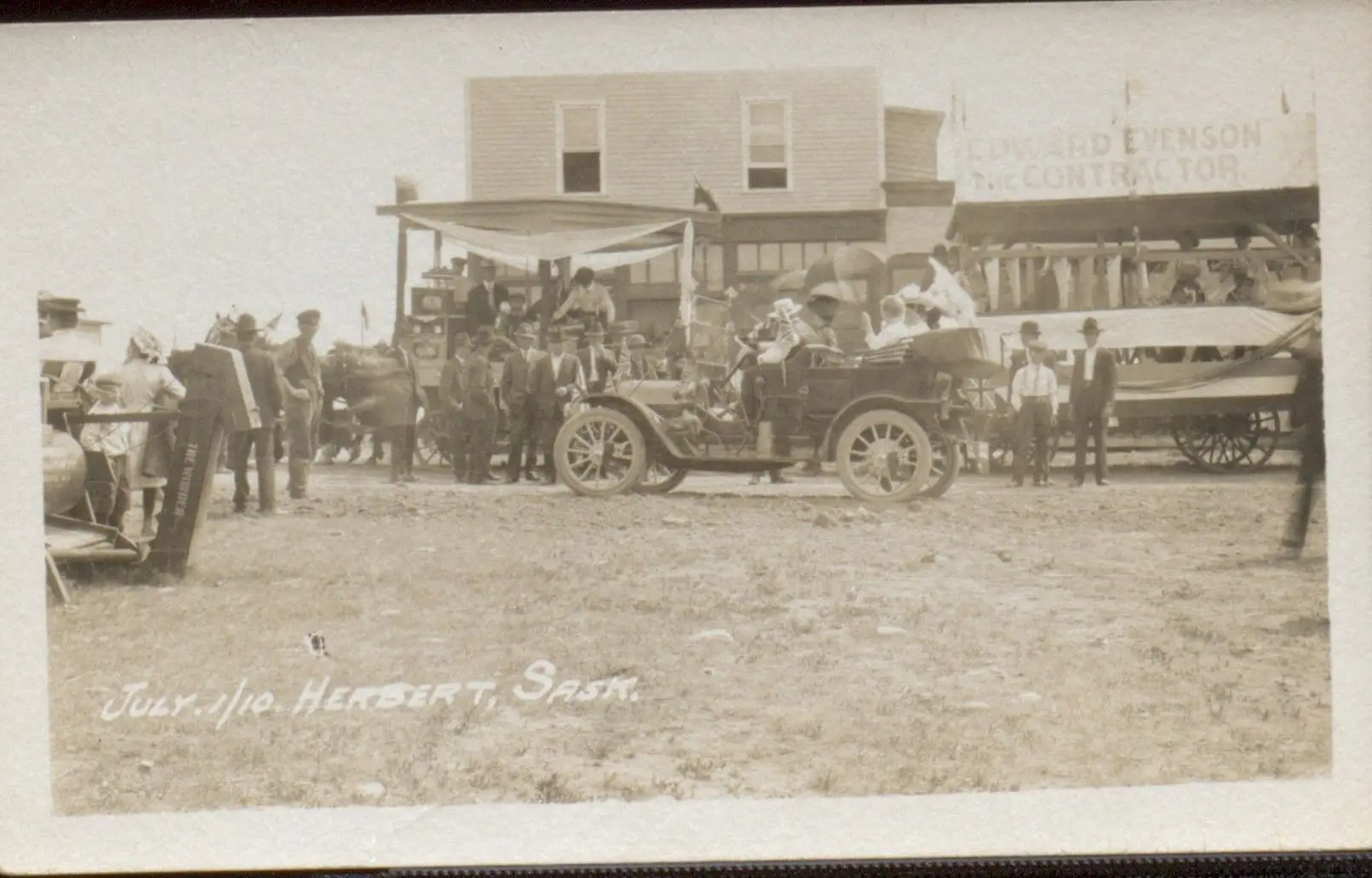 Parade with early automobile and floats, Herbert